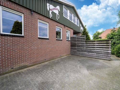 a brick building with a horse on the side of it at Eibergen s Holiday Haven in Eibergen