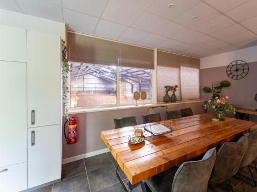 a dining room with a wooden table and chairs at Eibergen s Holiday Haven in Eibergen
