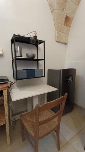a kitchen with a white table and a refrigerator at B&B VIA NAPOLI LEVERANO in Leverano