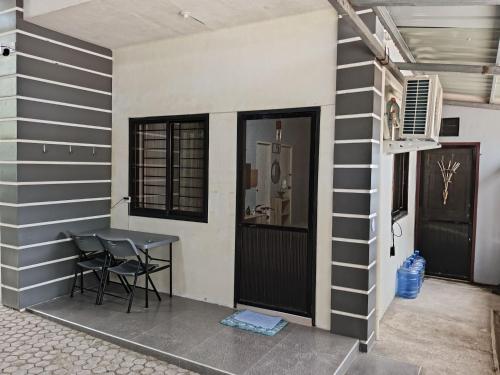 a room with a table and a window and a door at Your Home in Tagum City - Perfect for Families in San Isidro