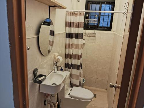 a small bathroom with a sink and a toilet at Your Home in Tagum City - Perfect for Families in San Isidro