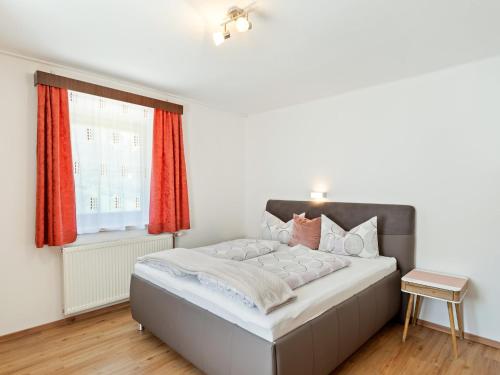 a bedroom with a large bed with red curtains at Apartment in Ötz near Hochoetz Ski Area in Sautens