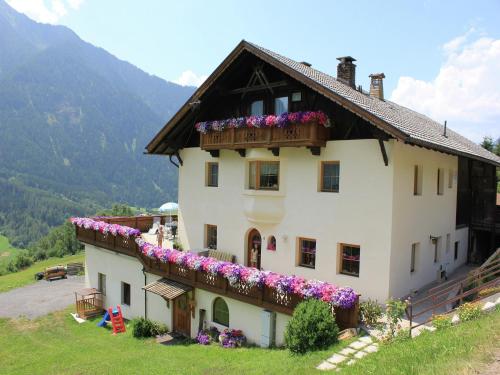 a house with flowers on the side of it at Apartment in Ötz near Hochoetz Ski Area in Sautens