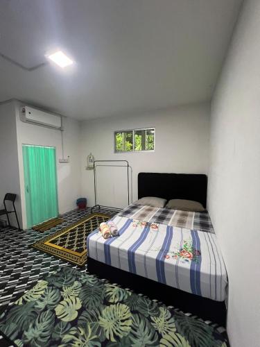 a bedroom with a bed in a room at Guest House 2 in Kuala Terengganu