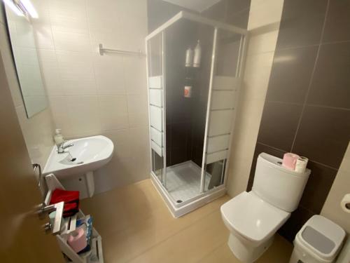 a bathroom with a shower and a toilet and a sink at Chalet Calpe mar y peñón in Calpe