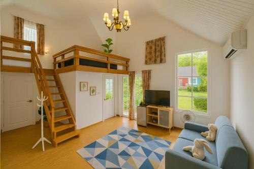 a living room with a blue couch and a bunk bed at XCLUSIVE-7lAyutthayalX-7อยุธยา in Phra Nakhon Si Ayutthaya