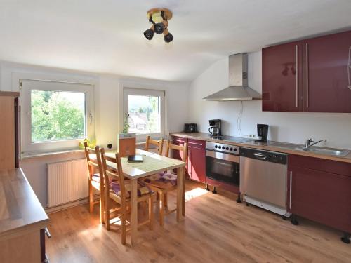 a kitchen with a table and a stove and cabinets at Entspannender Skiurlaub in Braunlage in Hohegeiß