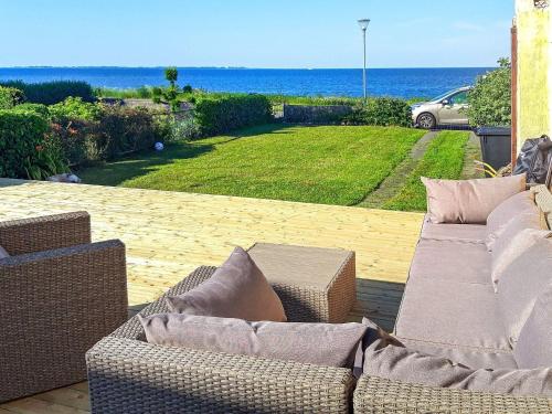 a patio with two couches and a view of the ocean at Seaside Retreat in Bandholm-By Traum in Bandholm