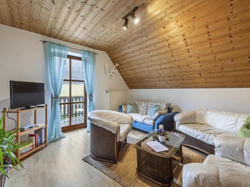 a living room with a wooden ceiling at Alluring Apartment in Schönsee in the forest in Schönsee