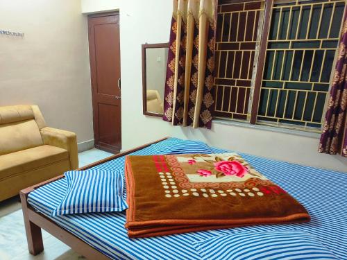 a blanket on top of a bed in a room at Hotel Golden Touch in Digha