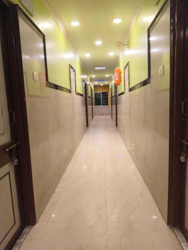 a hallway with a long corridor with doors and tile floors at Hotel Golden Touch in Digha