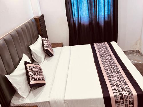 a bedroom with a bed with two pillows on it at Haveliya Homes- Just 1 minute from Railway Station and Connaught place in New Delhi