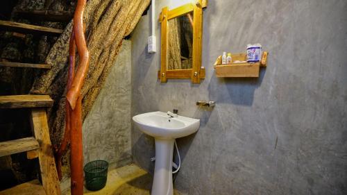 a bathroom with a sink and a mirror at Farming Tree House in Sigiriya