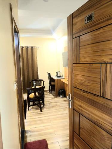 a door leading to a dining room with a table at The Boho Mussoorie in Mussoorie