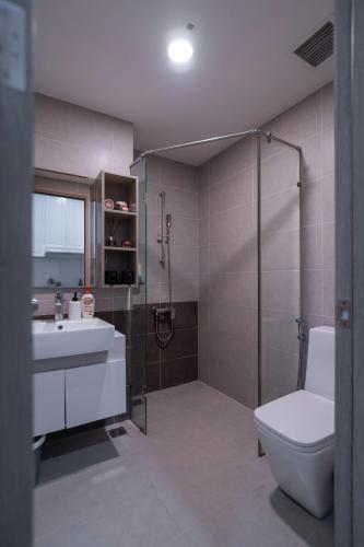 a bathroom with a shower and a toilet and a sink at The Sun Avenue Apartment Moonlight in Ho Chi Minh City