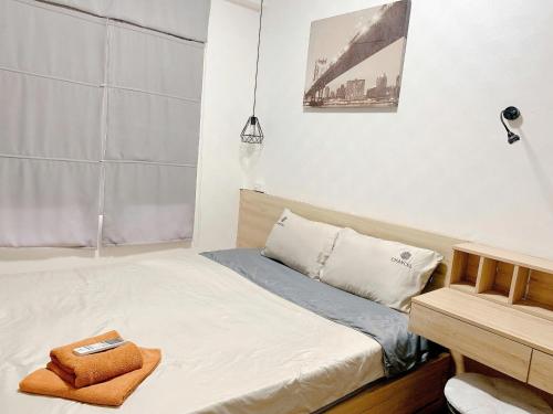 a small bedroom with a bed and a desk at The Sun Avenue Apartment Moonlight in Ho Chi Minh City