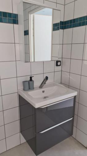 a bathroom with a sink and a mirror at Tente lodge la perche in Le Lonzac