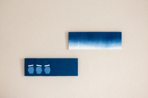 two pictures of blue shoes on a wall at Centrair Hotel in Tokoname