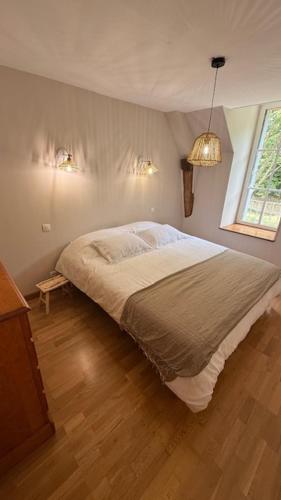 a bedroom with a large bed in a room at La Grange de la Boutelaye in Lésigny