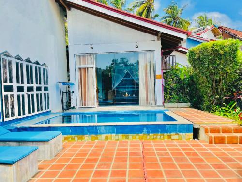 a swimming pool in the backyard of a house at Waterland in Negombo