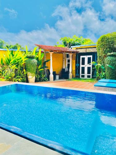 a swimming pool in front of a house at Waterland in Negombo