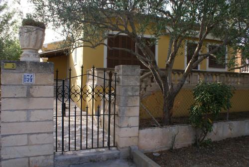a black wrought iron gate in front of a house at Ca'n Pedro in Sa Coma