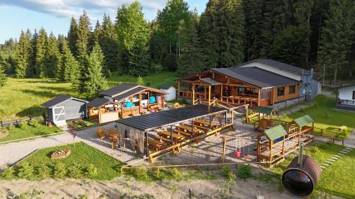an aerial view of a log home with a house at CLUBUL DACILOR in Comandău