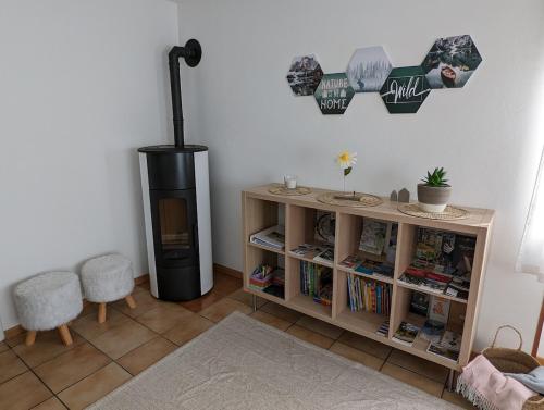 a living room with a black refrigerator and a book shelf at Casa Da Tos - appartamento per 5 persone in Lavorgo