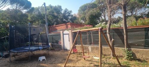 a playground with a swing set in a yard at Chambre face aux vignes in Vidauban
