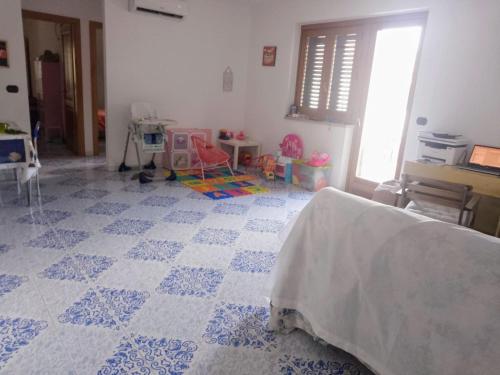 a bedroom with a blue and white tile floor at Giorni fantastici - appartamenti fronte mare in Marina di Ascea