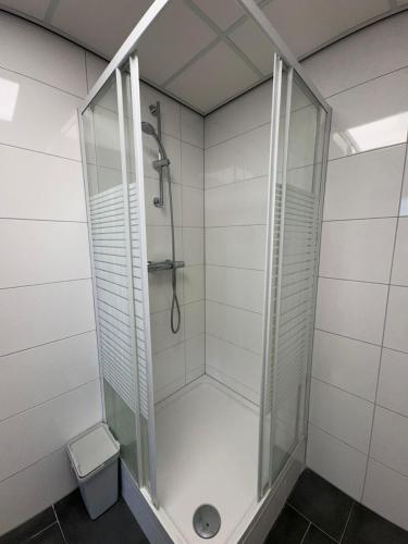 a shower with a glass enclosure in a bathroom at Getferweg 50-2 City Appartement in Enschede