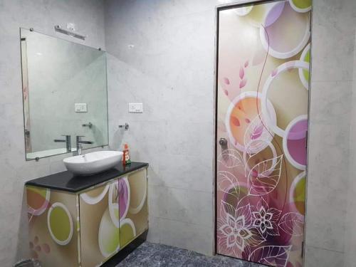 a bathroom with a sink and a mirror at C P Cottage Resort in Mahabaleshwar