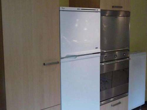 a refrigerator in a kitchen with a stove at Home in Comblain-au-Pont in Comblain-au-Pont