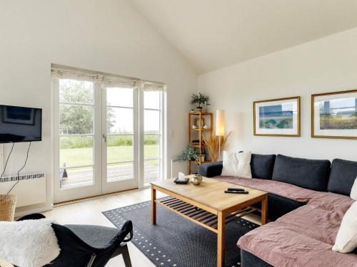 a living room with a couch and a table at 4 star holiday home in Nysted in Nysted