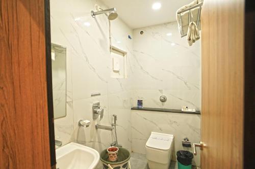 a bathroom with a sink and a toilet at Hotel Ekta International !! 300 Mts From BABA BAIDYANATH DHAM TEMPLE !! in Deoghar