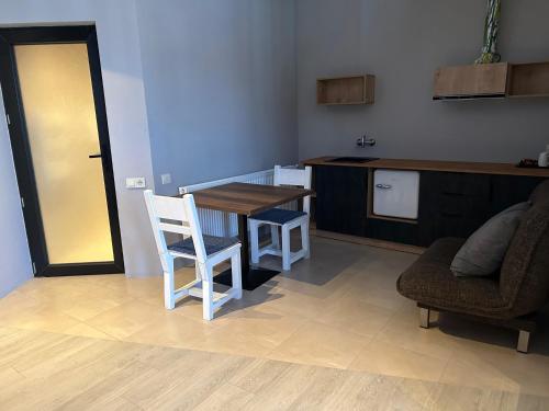 a kitchen with a table and two chairs and a counter at Chiko Group in Aspindza
