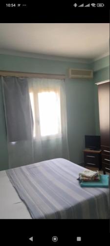 a bedroom with a white bed with a window at Nitro Inn Orikum - SEA and GARDEN in Orikum