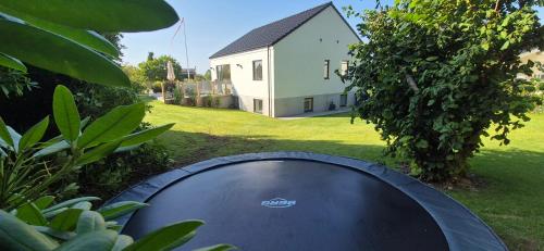 a trampoline in the yard of a house at Stylish villa in Vejle near Legoland -4 bedroom Incl Towels and bed linens in Vejle
