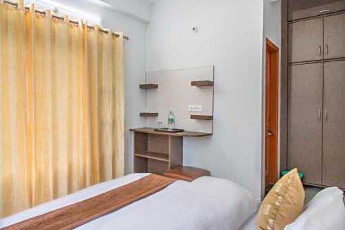a small bedroom with a bed and a desk at Exotic Stays I Pine Group Of Hotels & Villas Kasauli in Kasauli