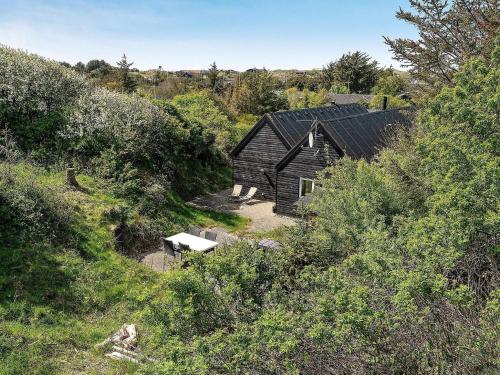an old house in the middle of a hill at 5 star holiday home in Blokhus in Blokhus