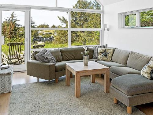 a living room with a couch and a coffee table at 5 star holiday home in Blokhus in Blokhus