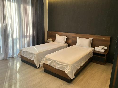 two beds in a hotel room with at Chiko Group in Aspindza