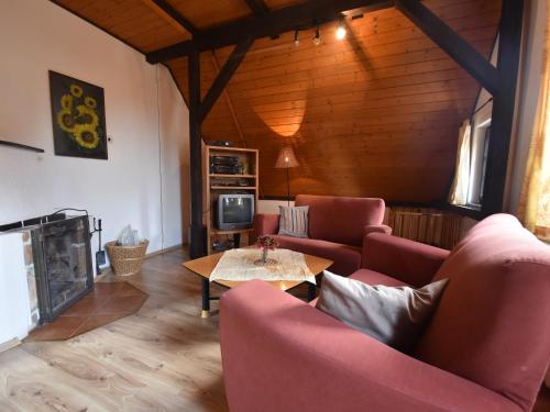 a living room with red couches and a fireplace at Holiday Home Abertamy near Ski Slopes in Abertamy