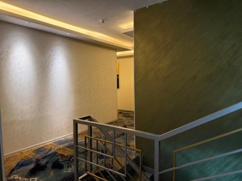 a hallway with a staircase in a building at Unity Hotel - Ulaanbaatar Railway Station in Ulaanbaatar