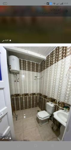 a bathroom with a toilet and a sink at Home of Natural in Luxor