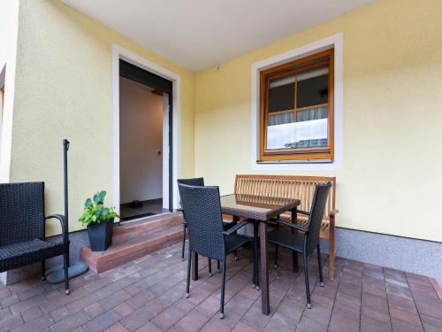 a patio with a table and chairs and a window at Chalet in Grossarl near Ski Slopes in Grossarl