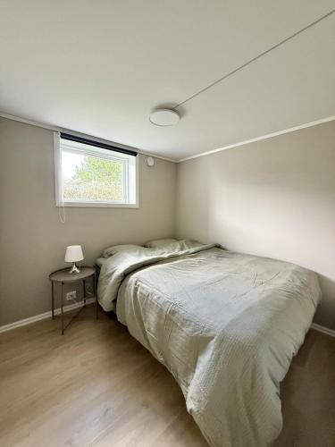 a bedroom with a large bed and a window at Downtown apartment in Stavanger