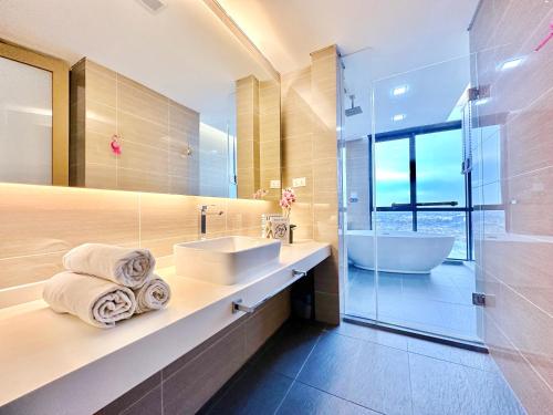 a bathroom with a sink and a tub and a shower at Alviv 99 Suites I Family Suite I 4-7 pax I 5minsMelakaCruise I JonkerSt in Melaka