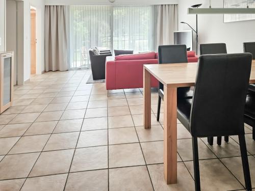 a living room with a table and a couch at Zuhause in den Alpen Ihre Ferienwohnung mit Hallenbad und Sauna in Lenzerheide