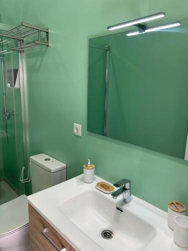 a bathroom with a sink and a mirror at Casa Cuatro Esquinas in Utrera